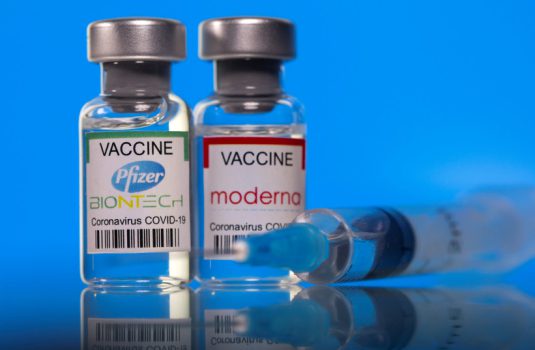 Vials with Pfizer-BioNTech and Moderna coronavirus disease (COVID-19) vaccine labels are seen in this illustration picture taken March 19, 2021. (photo credit: REUTERS/DADO RUVIC/ILLUSTRATION/FILE PHOTO)